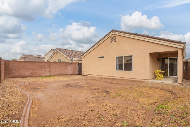 exterior space with a fenced backyard and a patio