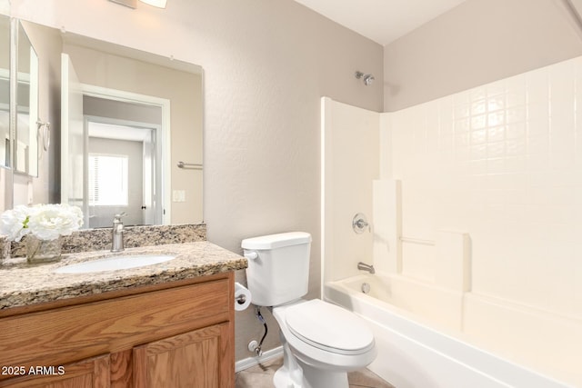 bathroom featuring tub / shower combination, vanity, and toilet