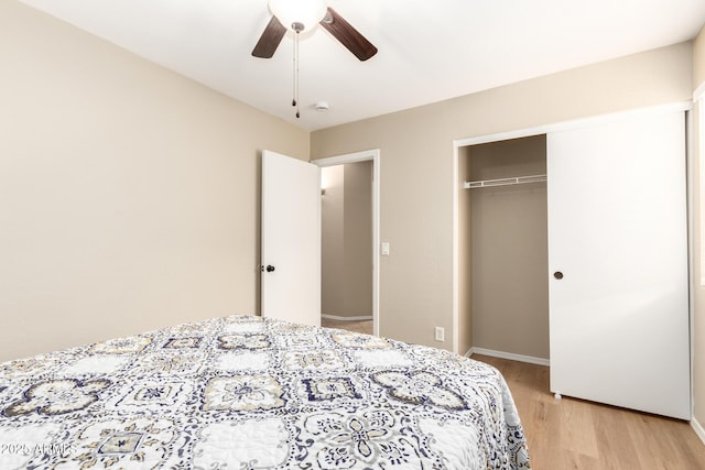 bedroom with a ceiling fan, a closet, baseboards, and light wood finished floors