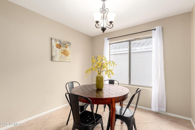 dining space with an inviting chandelier, baseboards, and light tile patterned floors