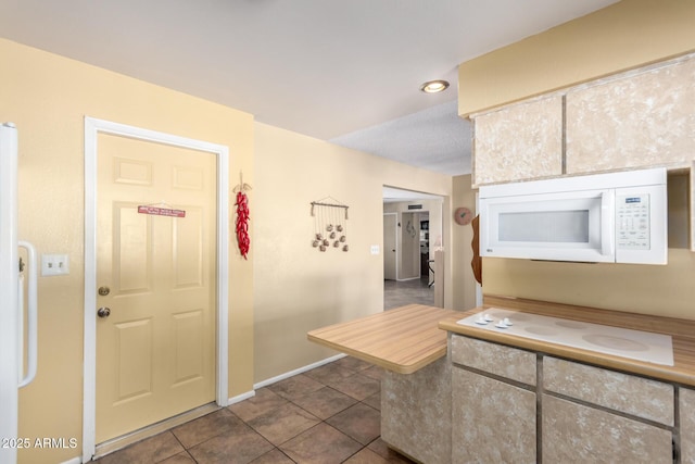 kitchen featuring dark tile patterned flooring