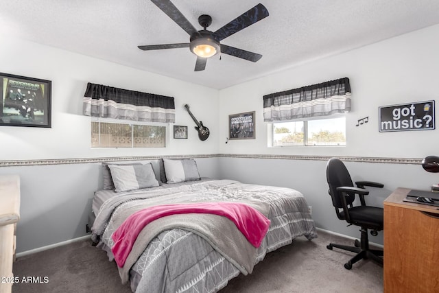 bedroom with ceiling fan, carpet floors, and a textured ceiling