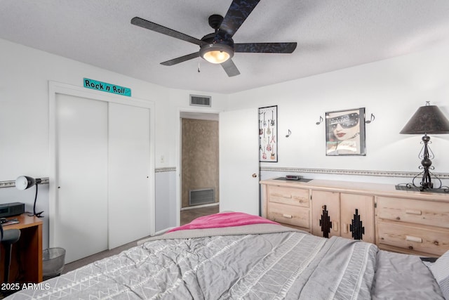 bedroom featuring ceiling fan, a closet, and a textured ceiling