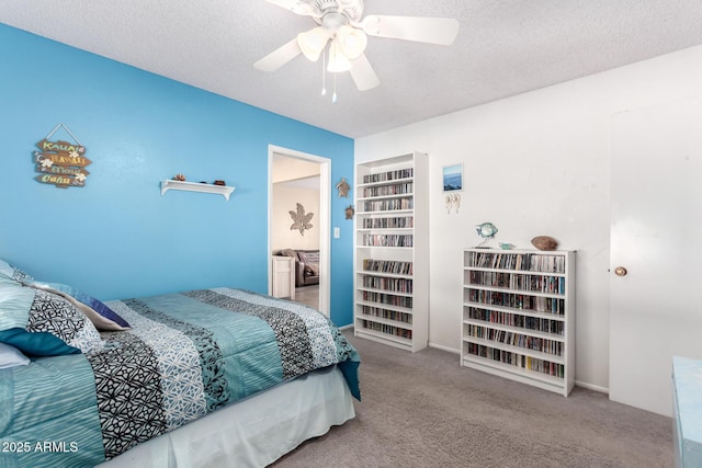 carpeted bedroom with ceiling fan and a textured ceiling