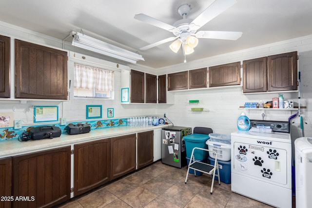 kitchen with separate washer and dryer, dark brown cabinets, and ceiling fan