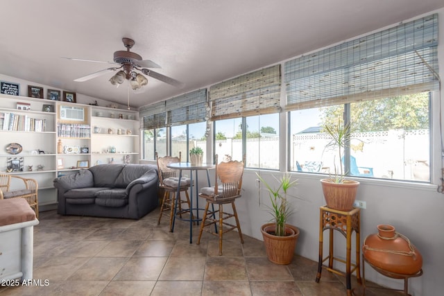 sunroom with ceiling fan and lofted ceiling