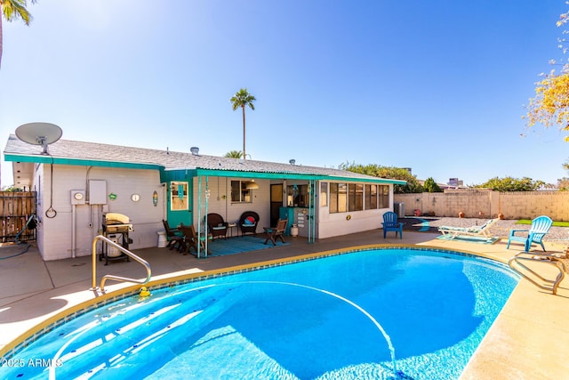 view of swimming pool with a patio area