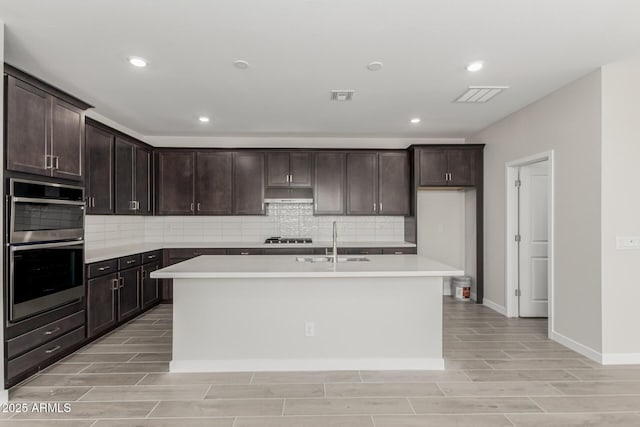 9416 E Sequence Ave, Mesa, AZ 85212 - kitchen with double oven, tasteful backsplash, wood finish floors, light countertops, and recessed lighting