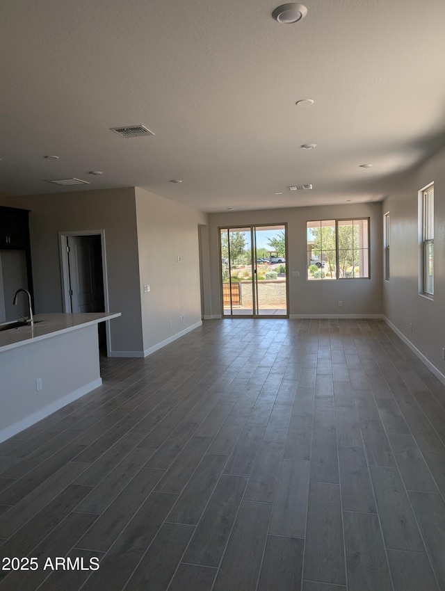 9416 E Sequence Ave, Mesa, AZ 85212 - unfurnished living room with dark wood-style flooring