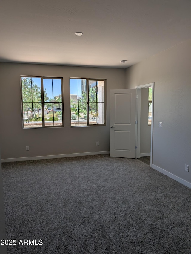 9416 E Sequence Ave, Mesa, AZ 85212 - empty room with healthy amount of natural light and dark colored carpet