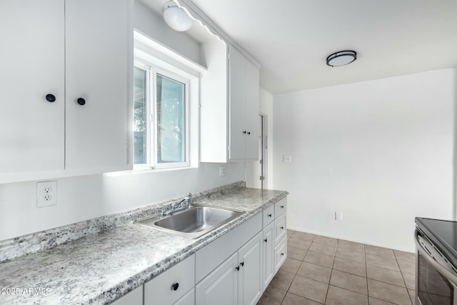 kitchen featuring sink, white cabinets, stainless steel electric range oven, and light tile patterned floors