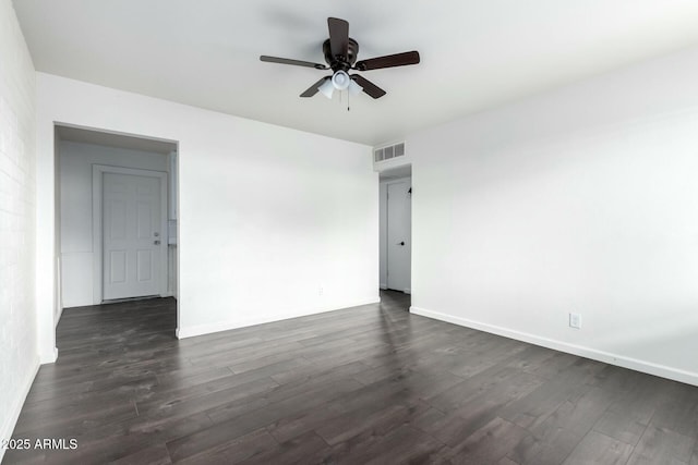 spare room with ceiling fan and dark wood-type flooring