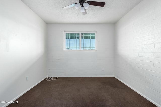 carpeted spare room featuring ceiling fan, brick wall, and a textured ceiling