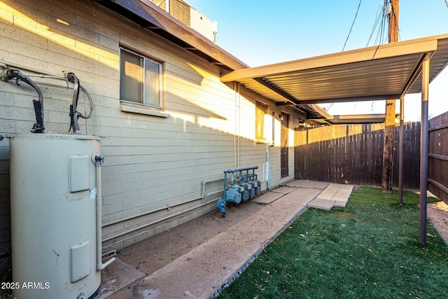 exterior space with a lawn and water heater