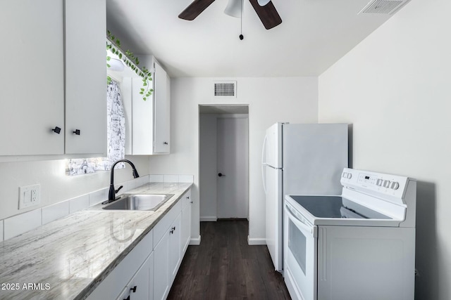 kitchen featuring sink, white electric stove, white cabinetry, and dark hardwood / wood-style flooring