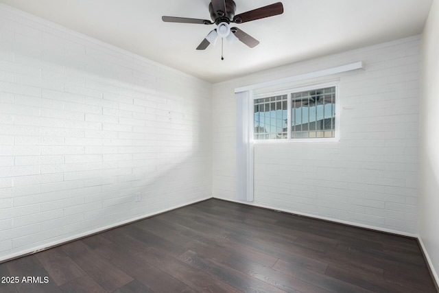 spare room featuring dark hardwood / wood-style floors and ceiling fan