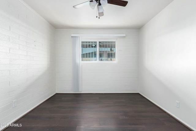 spare room featuring ceiling fan and dark wood-type flooring