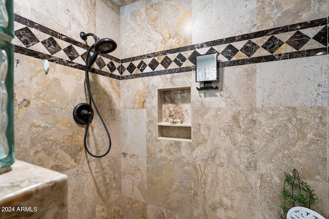 interior details featuring tiled shower