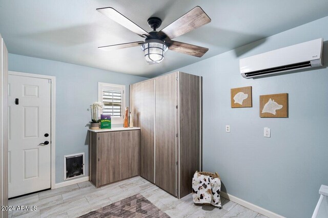 foyer featuring a wall mounted AC and ceiling fan