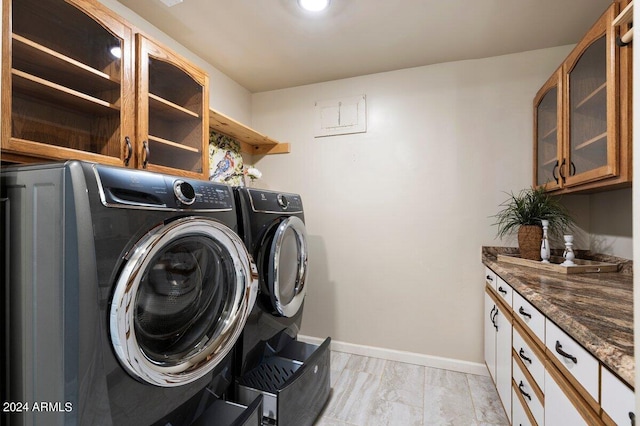 laundry area with cabinets and washer and clothes dryer