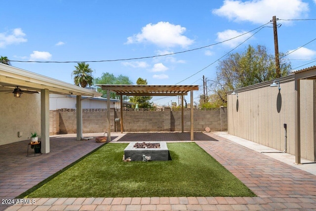 view of yard featuring a patio, a pergola, and an outdoor fire pit