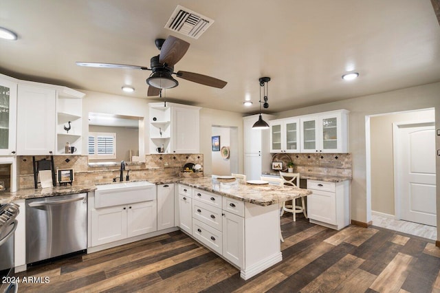 kitchen with pendant lighting, sink, white cabinets, kitchen peninsula, and stainless steel appliances