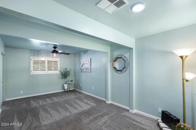 spare room featuring carpet flooring and ceiling fan