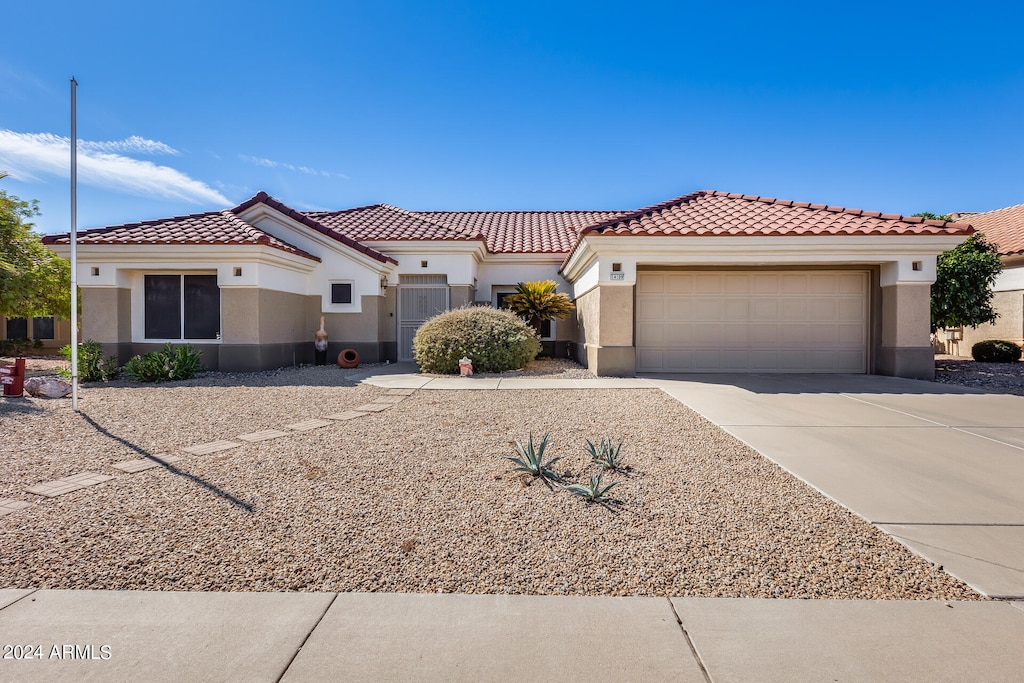 mediterranean / spanish-style home featuring a garage