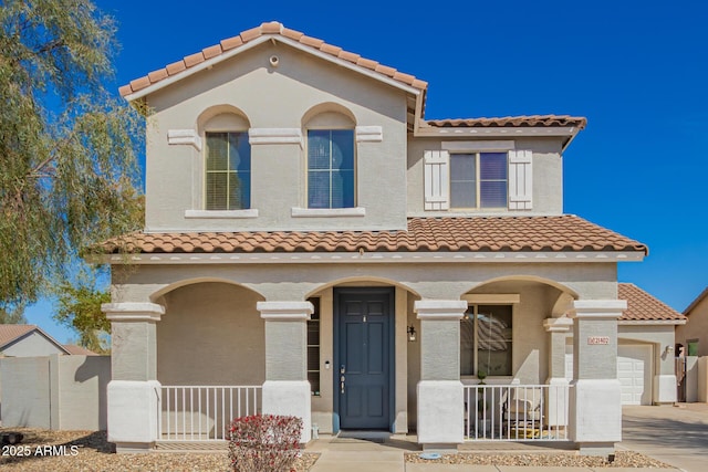 mediterranean / spanish-style home featuring stucco siding, a porch, and concrete driveway