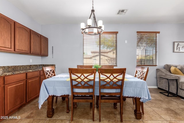 dining room featuring visible vents, plenty of natural light, a notable chandelier, and baseboards