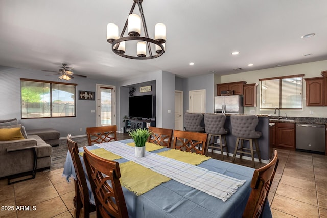 dining area with light tile patterned floors, recessed lighting, ceiling fan with notable chandelier, and baseboards