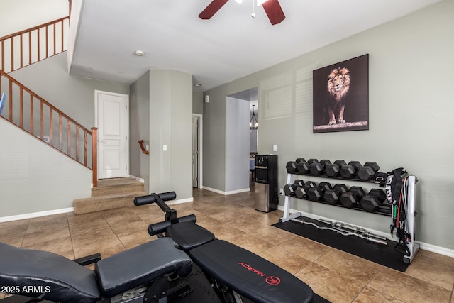 workout room featuring ceiling fan and baseboards