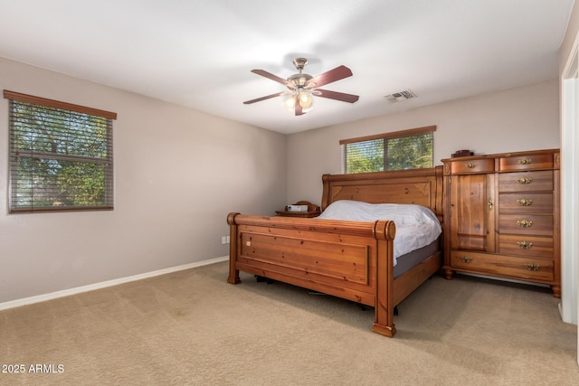 bedroom featuring a ceiling fan, baseboards, visible vents, and light carpet