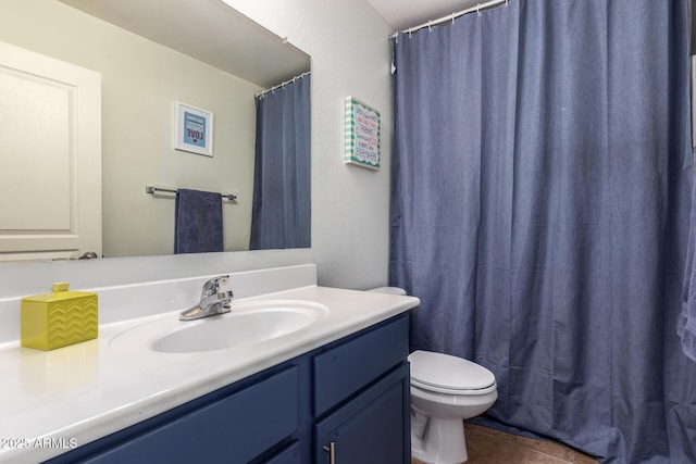 bathroom with vanity, toilet, and tile patterned flooring