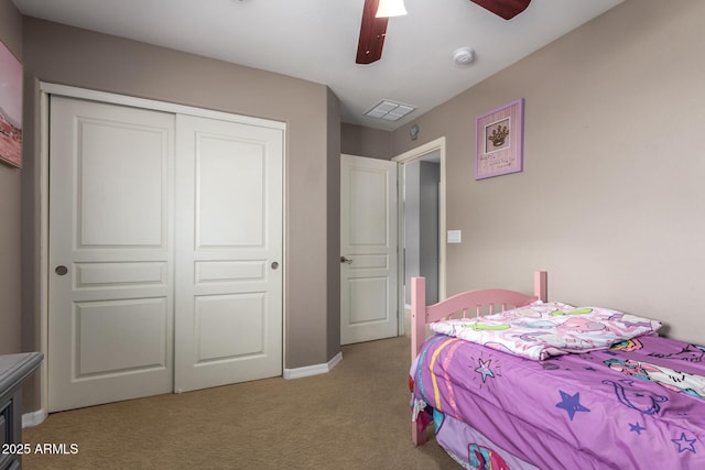 bedroom with a ceiling fan, visible vents, a closet, and light carpet