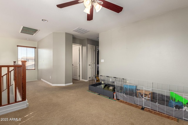 interior space with visible vents, ceiling fan, baseboards, and carpet floors