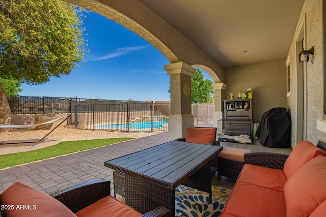 view of patio / terrace with an outdoor living space, a fenced backyard, and a fenced in pool