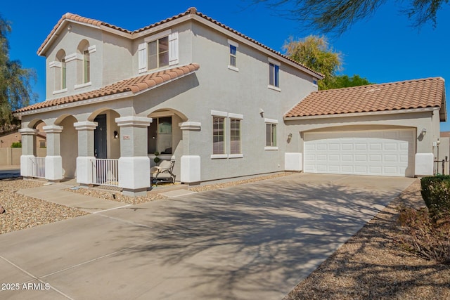 mediterranean / spanish-style home featuring stucco siding, a garage, covered porch, and a tiled roof