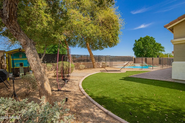 view of yard with a patio, fence, and a fenced in pool