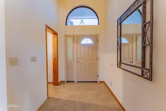 entryway featuring a towering ceiling