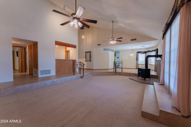 workout area with light carpet, high vaulted ceiling, a wood stove, and ceiling fan