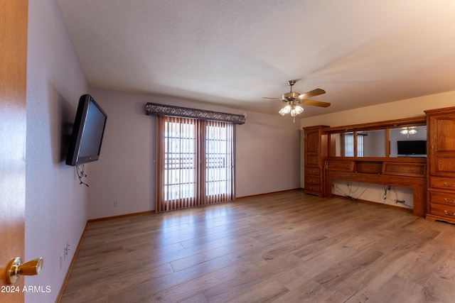 unfurnished living room featuring light hardwood / wood-style floors, a textured ceiling, and ceiling fan