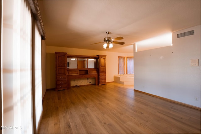 unfurnished living room with hardwood / wood-style floors and ceiling fan