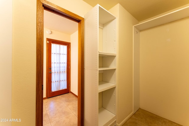 spacious closet with light tile patterned floors