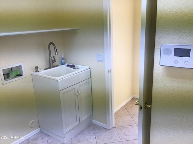 laundry room featuring a sink, hookup for a washing machine, laundry area, and light tile patterned flooring