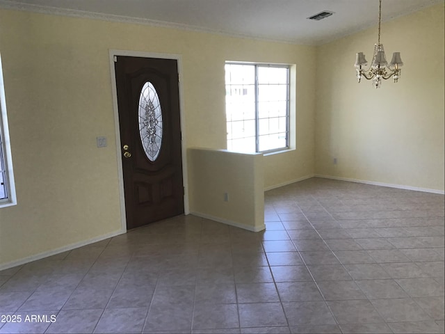 tiled entrance foyer featuring an inviting chandelier, baseboards, and visible vents