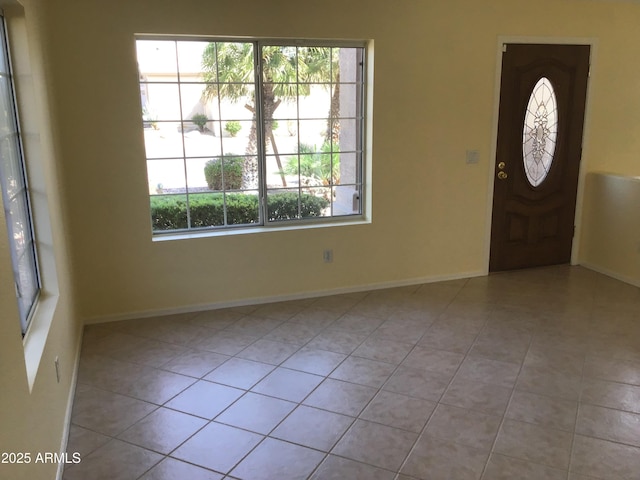 tiled entryway featuring baseboards