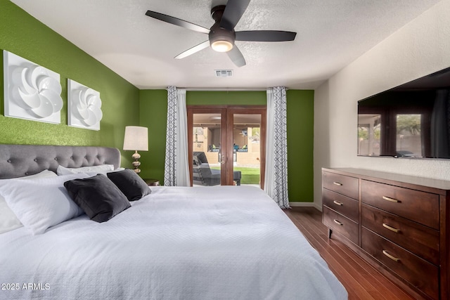 bedroom featuring visible vents, ceiling fan, dark wood-type flooring, access to exterior, and french doors