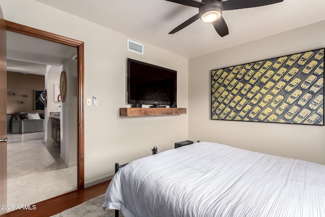 bedroom with visible vents, ceiling fan, baseboards, and wood finished floors