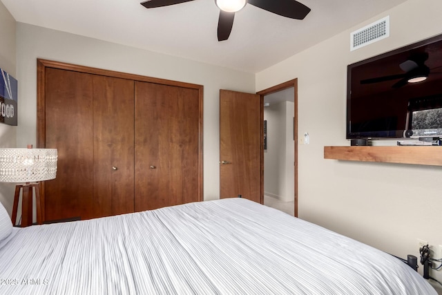 bedroom featuring a closet, visible vents, and a ceiling fan